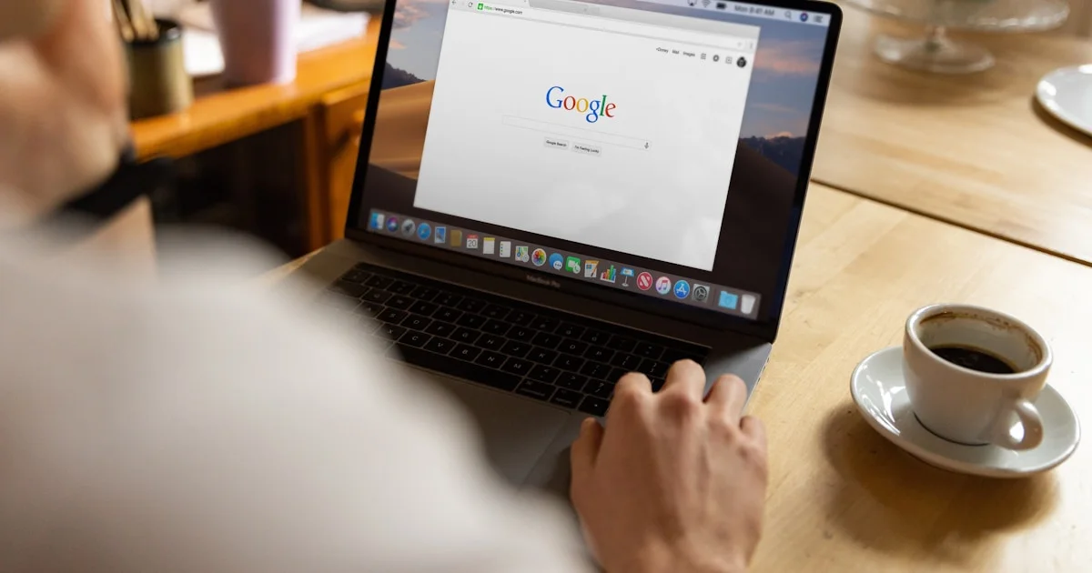 person using macbook pro on table