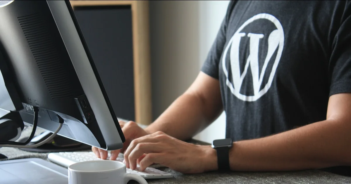 person in black and white t-shirt using computer
