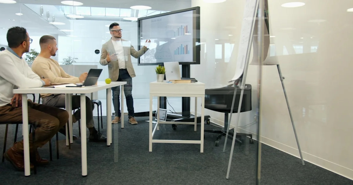 Man presenting to colleagues in a modern office.