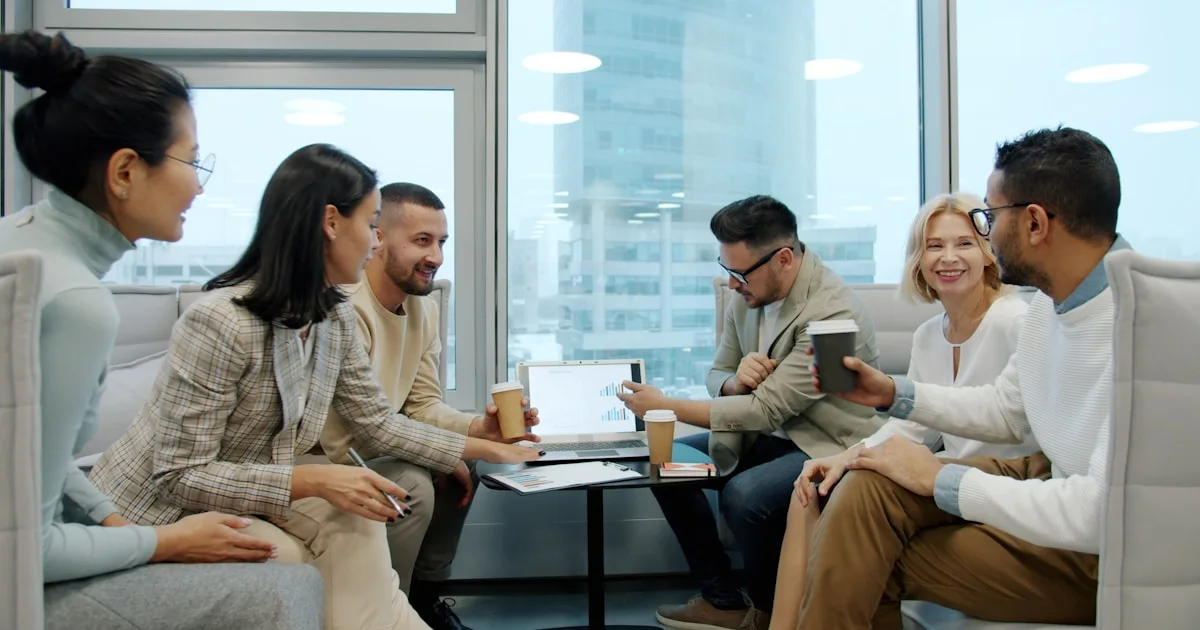 Diverse group of people in a modern office meeting.