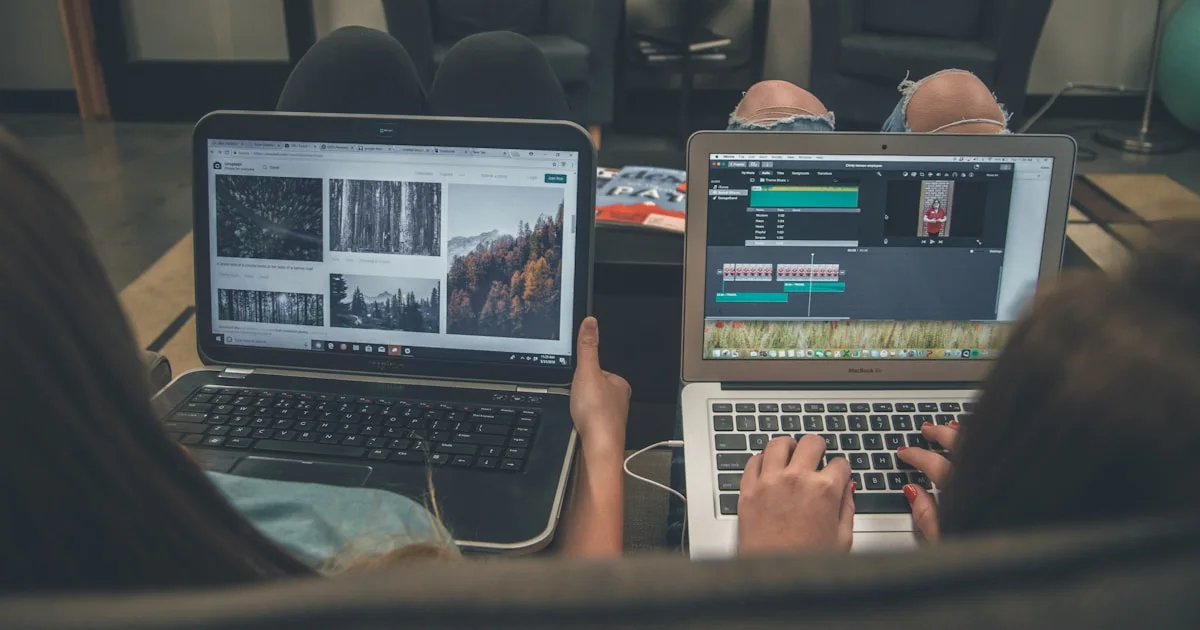 two person with laptop on lap sittig