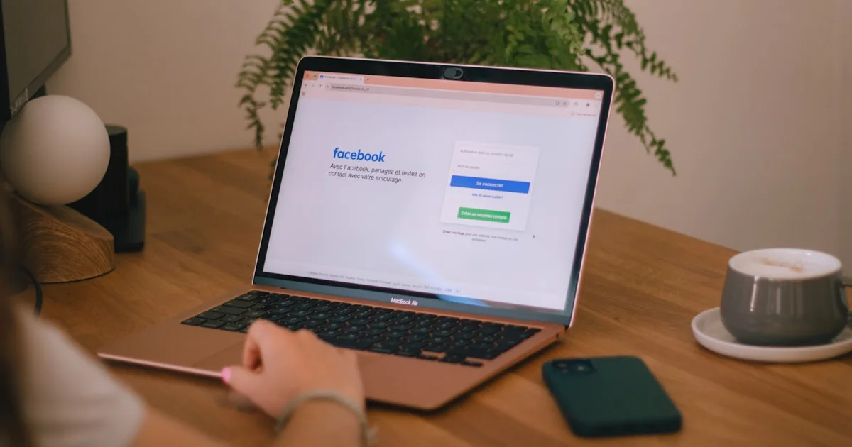 Laptop displays the facebook login page.