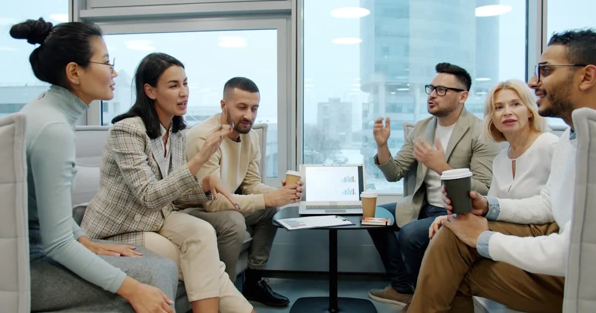 Diverse group of people in a modern office meeting.