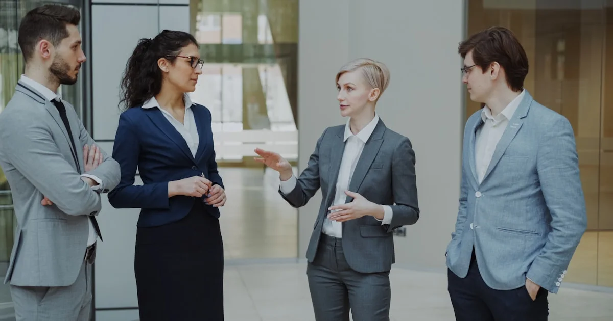 Four business professionals in a meeting discussing ideas.