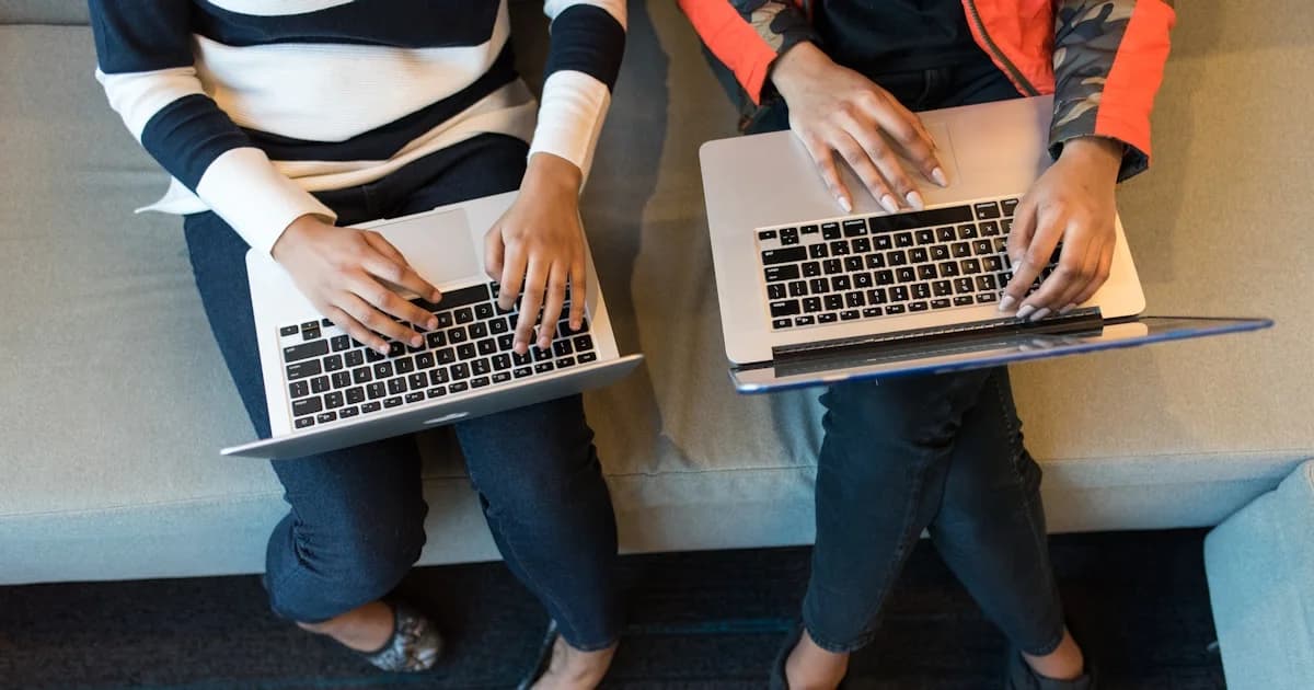 two women using MacBook Pro