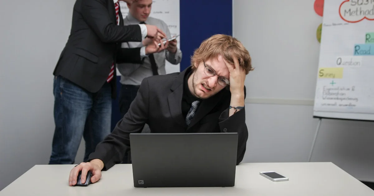 A man sitting in front of a laptop computer