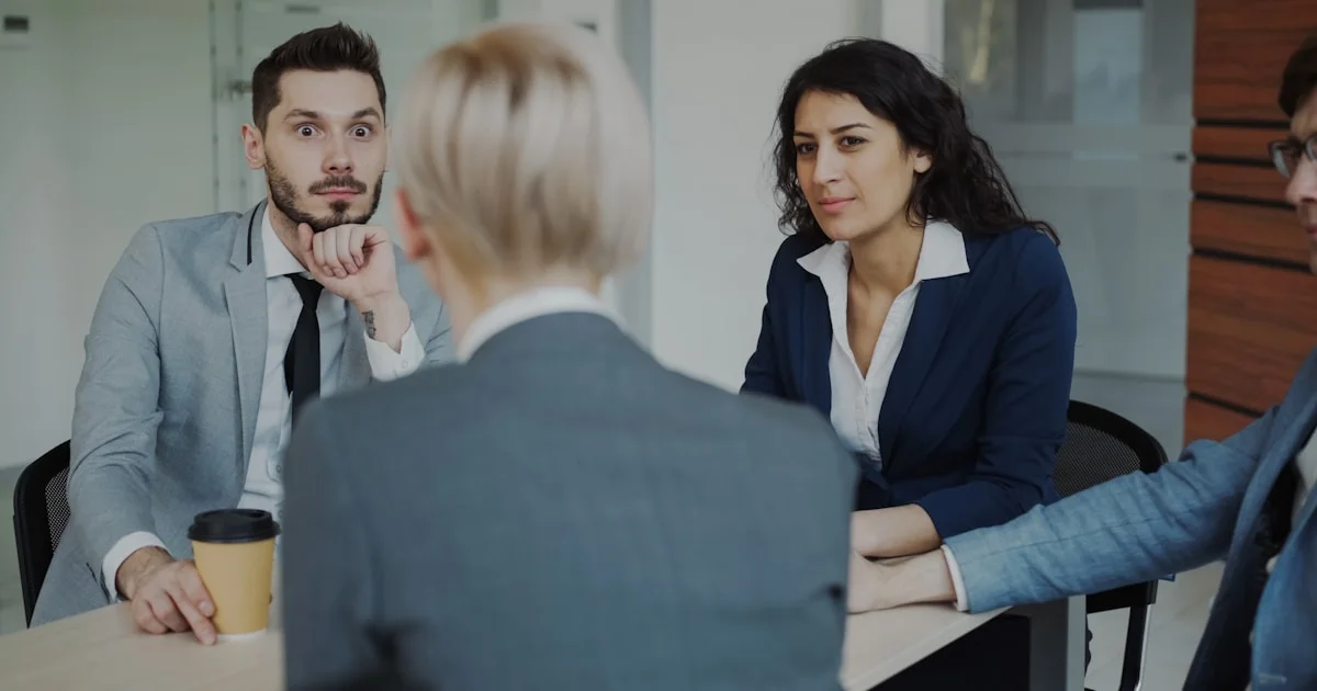 Business people in a meeting around a table.