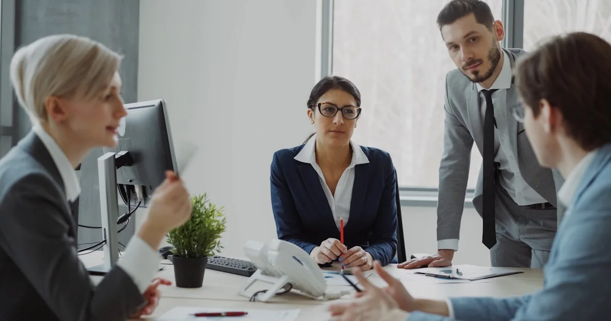 Business professionals collaborating in a modern office meeting.