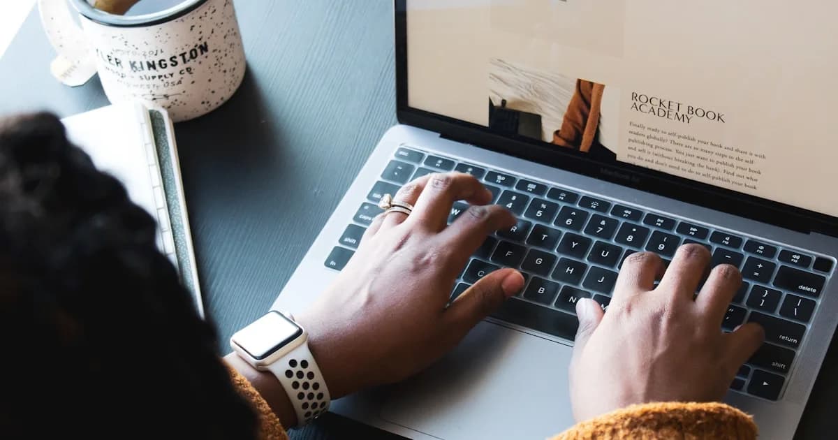 person using macbook pro on black table