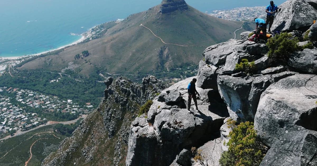 a group of people standing on top of a mountain