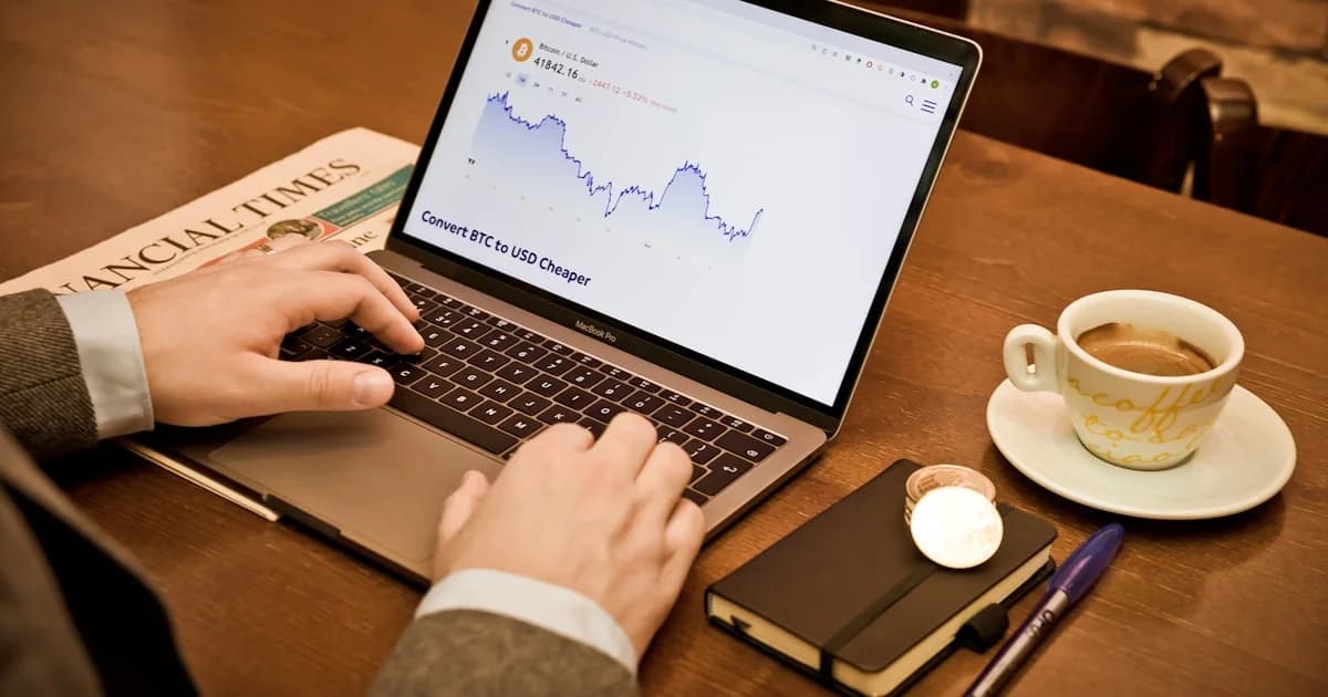 a person using a laptop on a wooden table