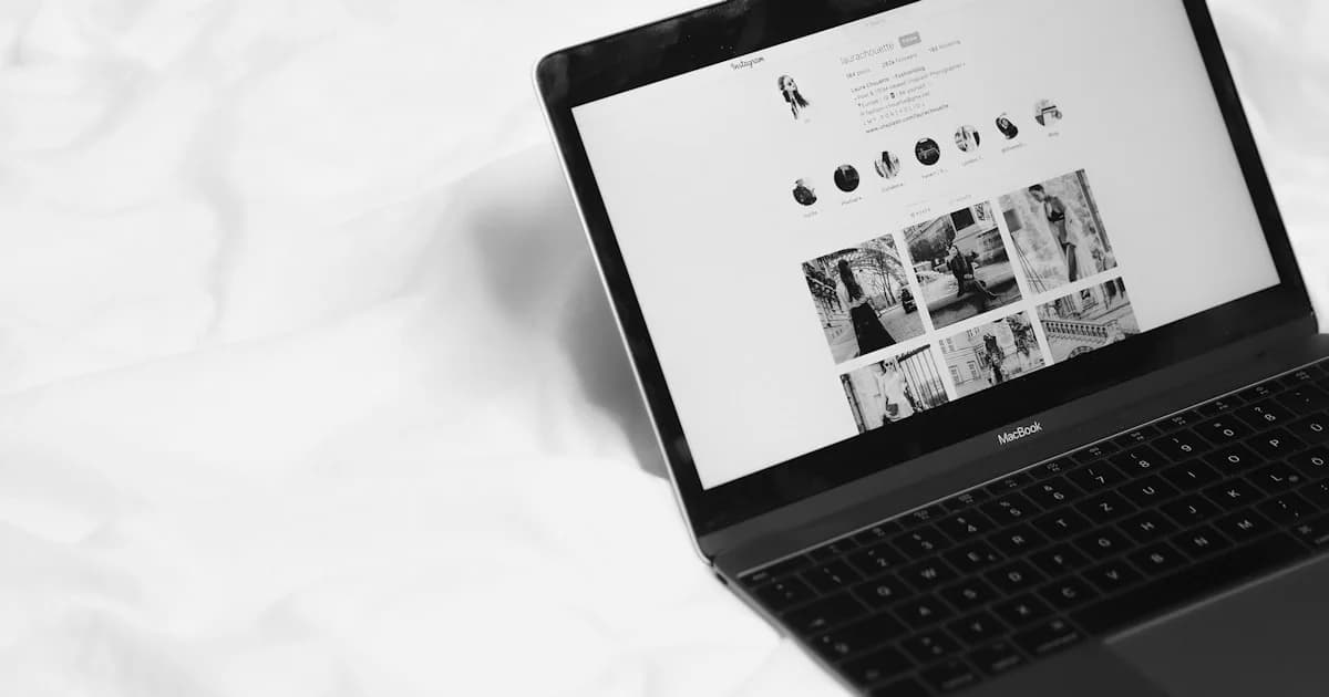 black laptop computer on white textile