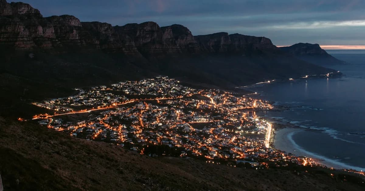 city near mountain during night time