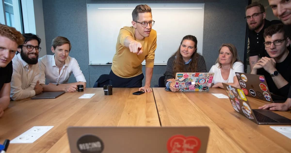 a group of people sitting around a wooden table