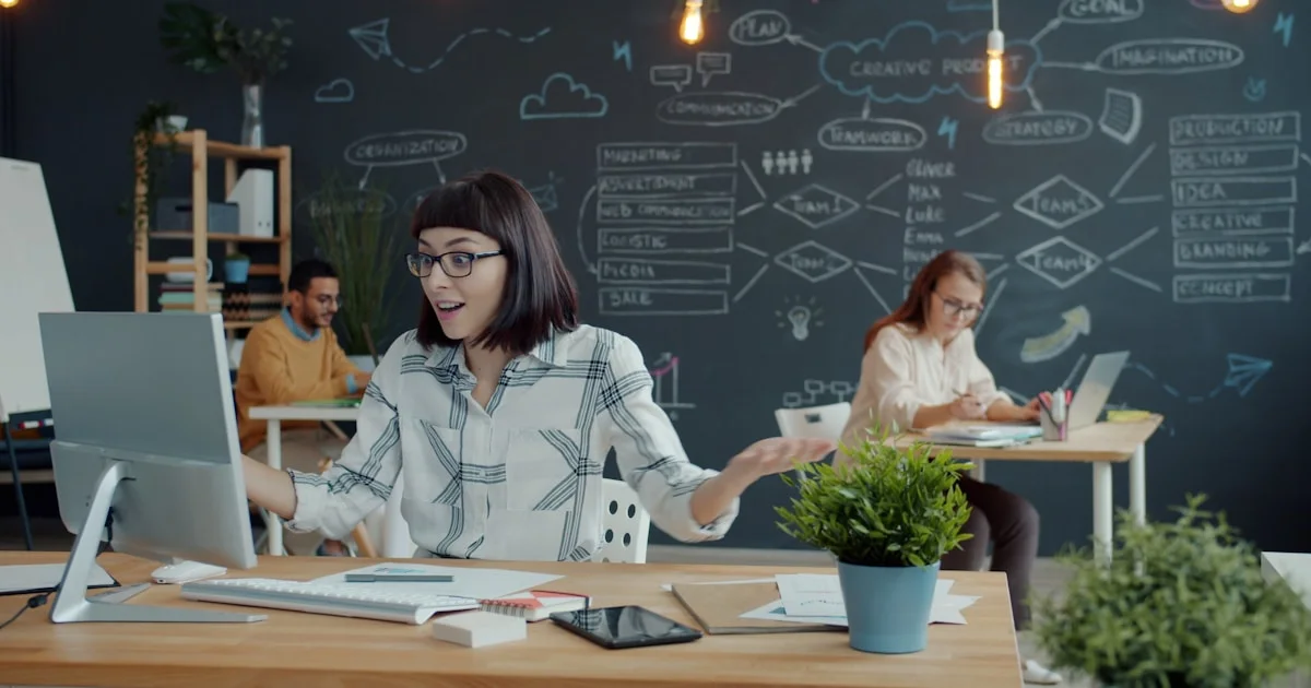 People working in a modern office with chalk drawings.