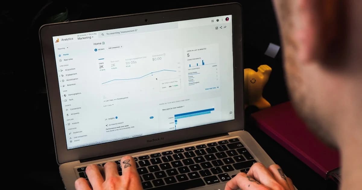 person using macbook pro on black table