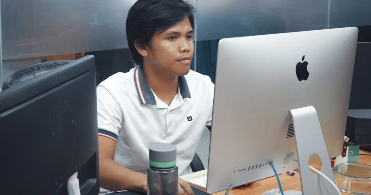 man in front of iMac