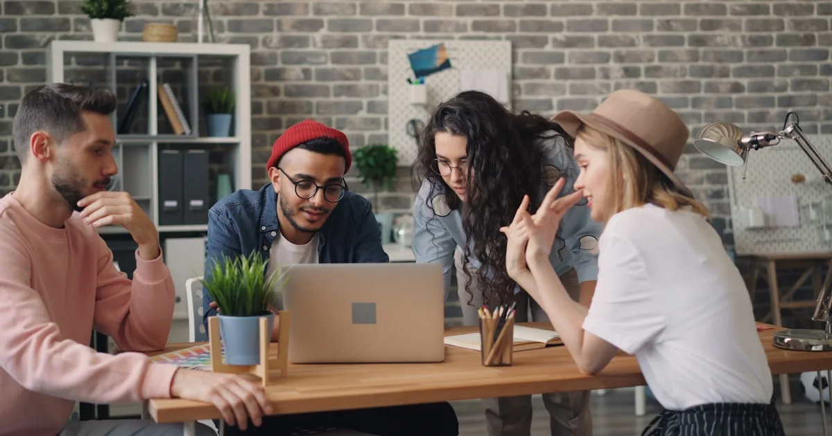 a group of people sitting around a wooden table
