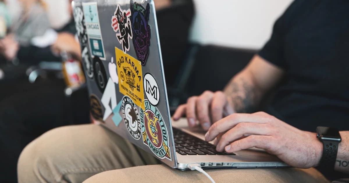 person using macbook pro on lap