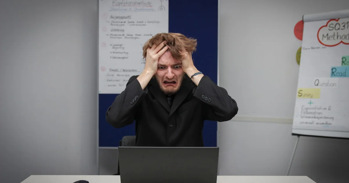 A man sitting in front of a laptop computer