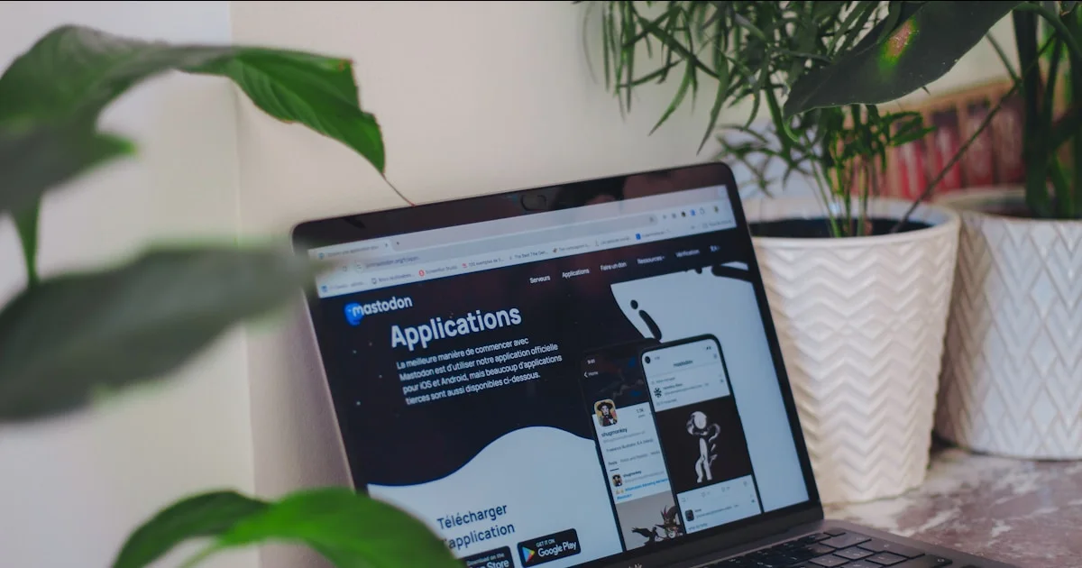 A laptop computer sitting on top of a wooden desk