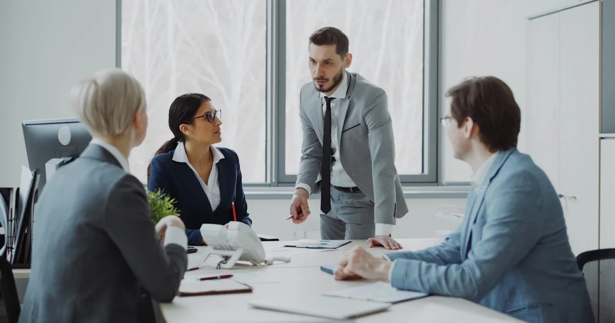 Business professionals in a meeting around a table.